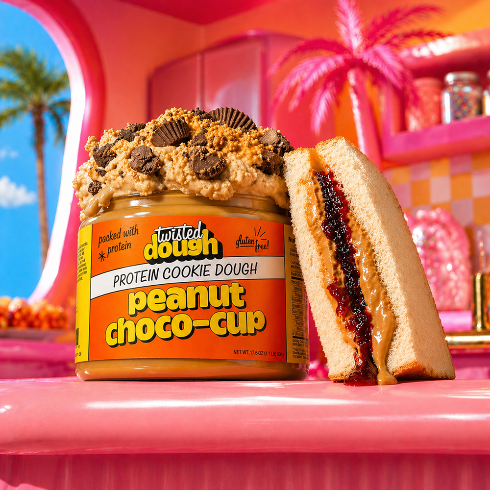 Twisted Dough Peanut Choco-Cup protein cookie dough jar with a sandwich on a pink background
