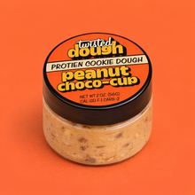 Load image into Gallery viewer, Jar of Twisted Dough Protein Cookie Dough Peanut Choco-Cup on an orange background