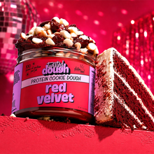 Load image into Gallery viewer, Jar of Twisted Dough Red Velvet Protein Cookie Dough with a slice of red velvet cake on a red background