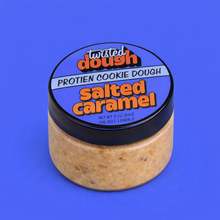 Load image into Gallery viewer, Jar of Twisted Dough Protein Cookie Dough in salted caramel flavor on a blue background