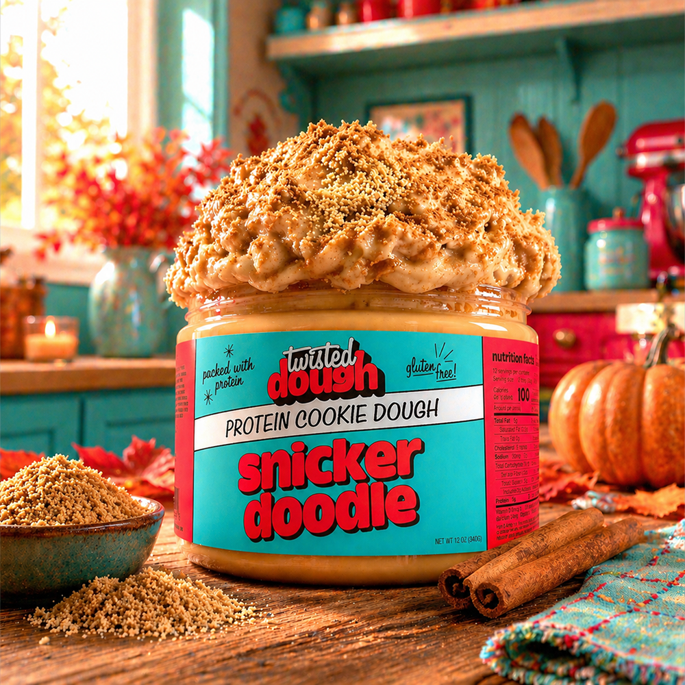 Jar of Twisted Dough Snickerdoodle Protein Cookie Dough with a cinnamon stick on a kitchen counter.