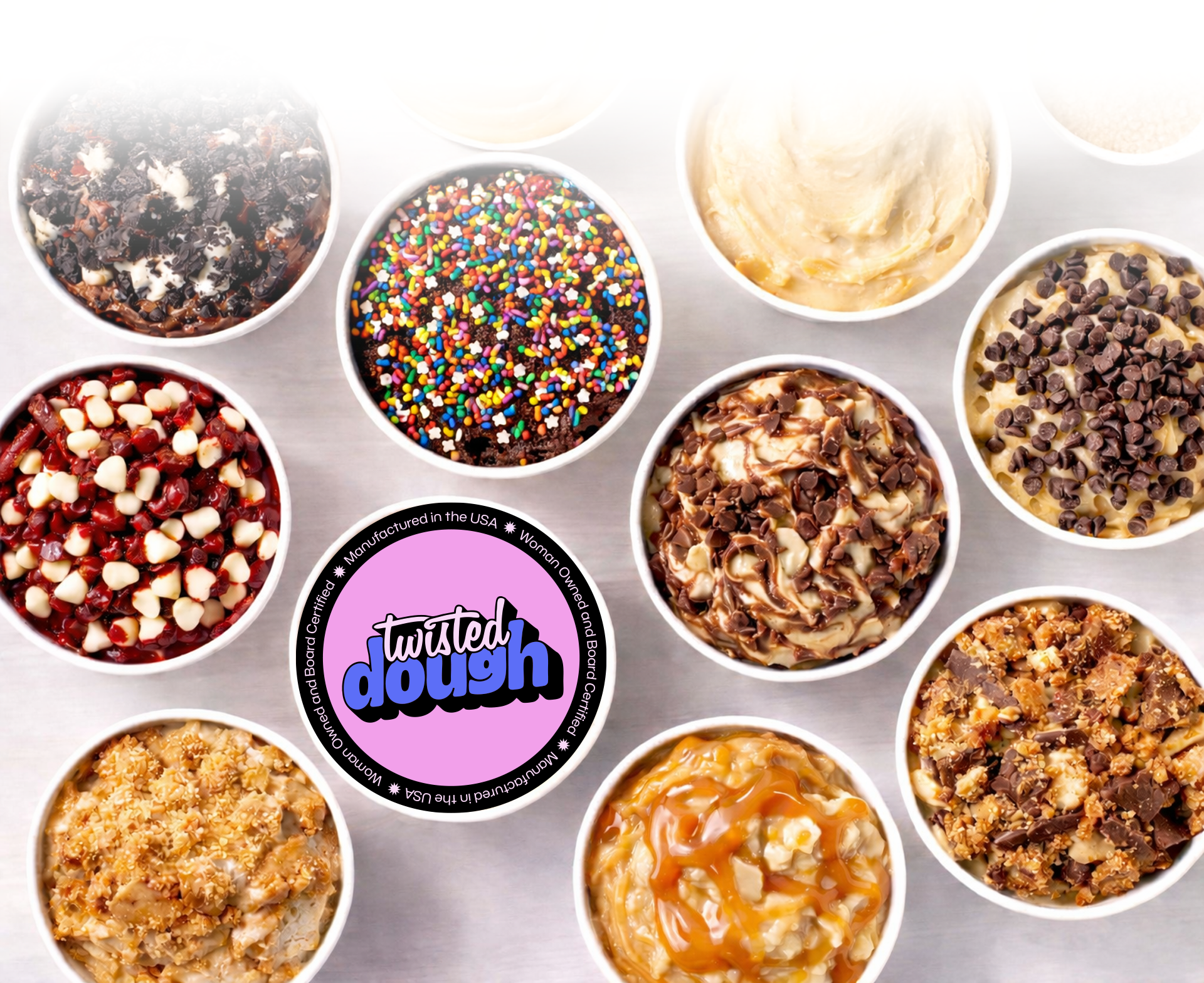 Assorted cookie dough flavors in bowls with Twisted Dough logo in the center.